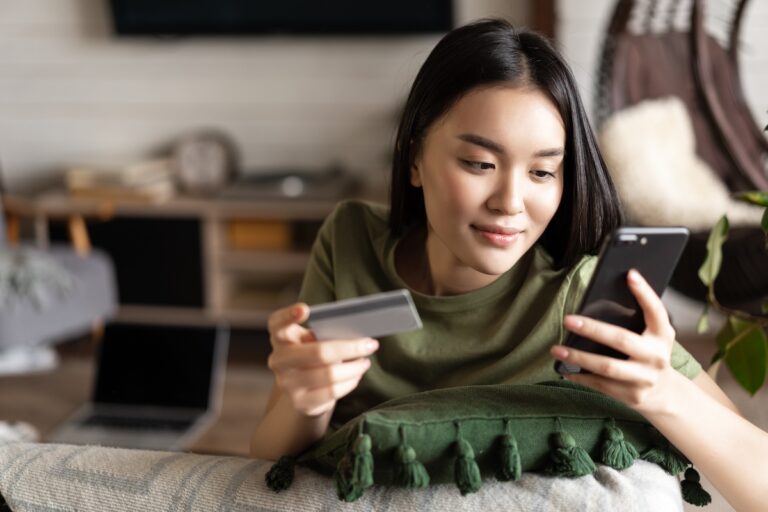 Woman online shopping on a cell phone